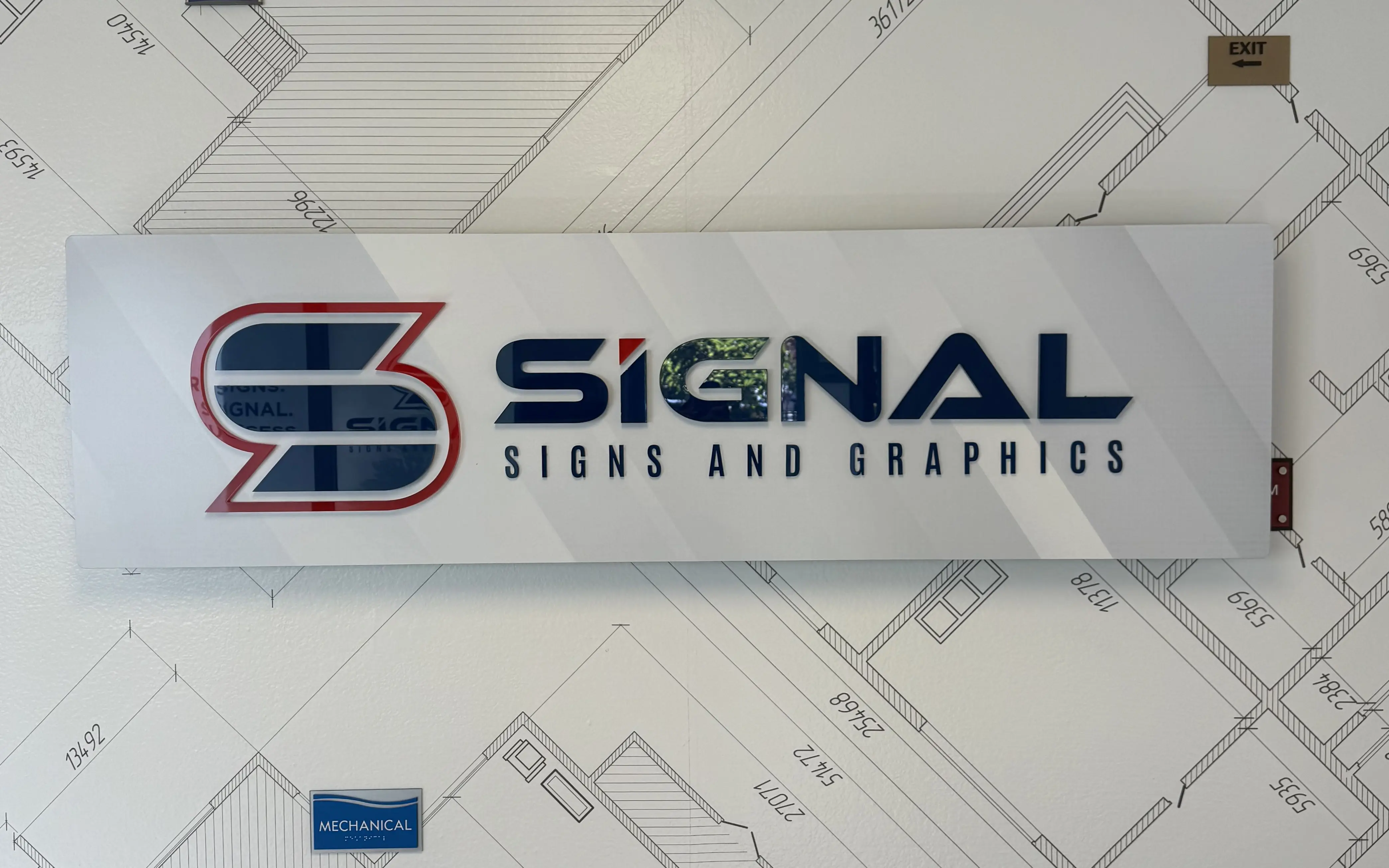 indoor acrylic signage installed in an office wall
